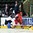 GRAND FORKS, NORTH DAKOTA - APRIL 14: The Slovakia bench looks on as their player Rastislav Vaclav #18 grabs hold of Denmark's Rasmus Mohr #24 as he attempts to play the puck during preliminary round action at the 2016 IIHF Ice Hockey U18 World Championship. (Photo by Minas Panagiotakis/HHOF-IIHF Images)

